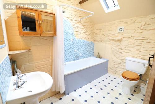 The bathroom with bath and shower over