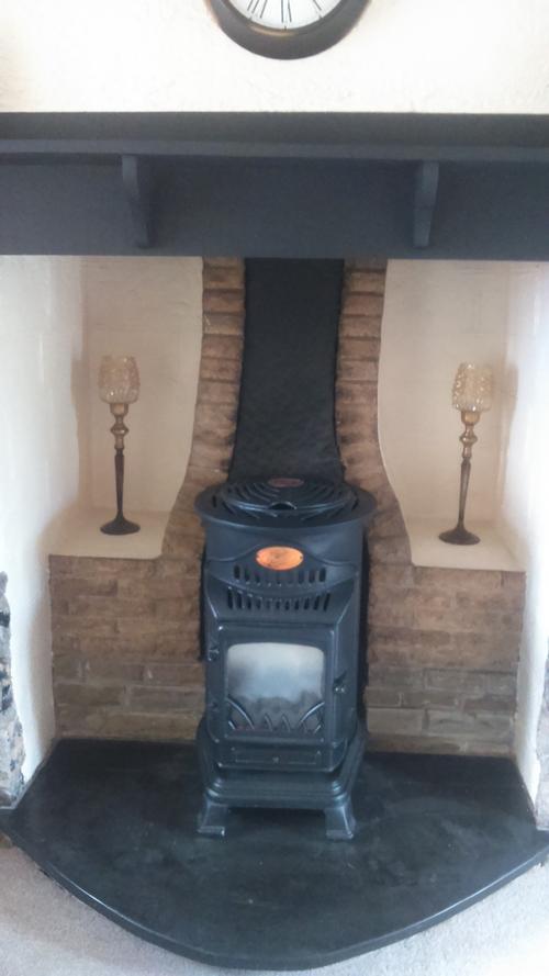 Gas effect woodburning stove set in inglenook fireplace in front lounge