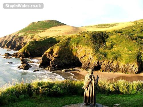 St Crannogs watches over the stunning beach at Llangrannog just a few minutes from Y Caban