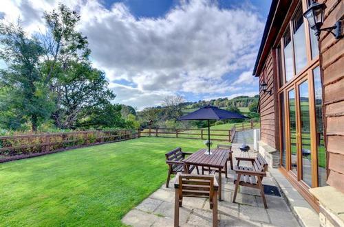 The enclosed garden with patio area, garden furniture and barbecue