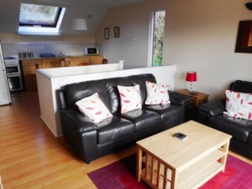 Living Room showing kitchen/dining area behind in Oak Lodge