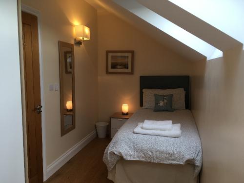 Bedroom 2. Upstairs bedroom sleeps 2 with two single beds either end of room